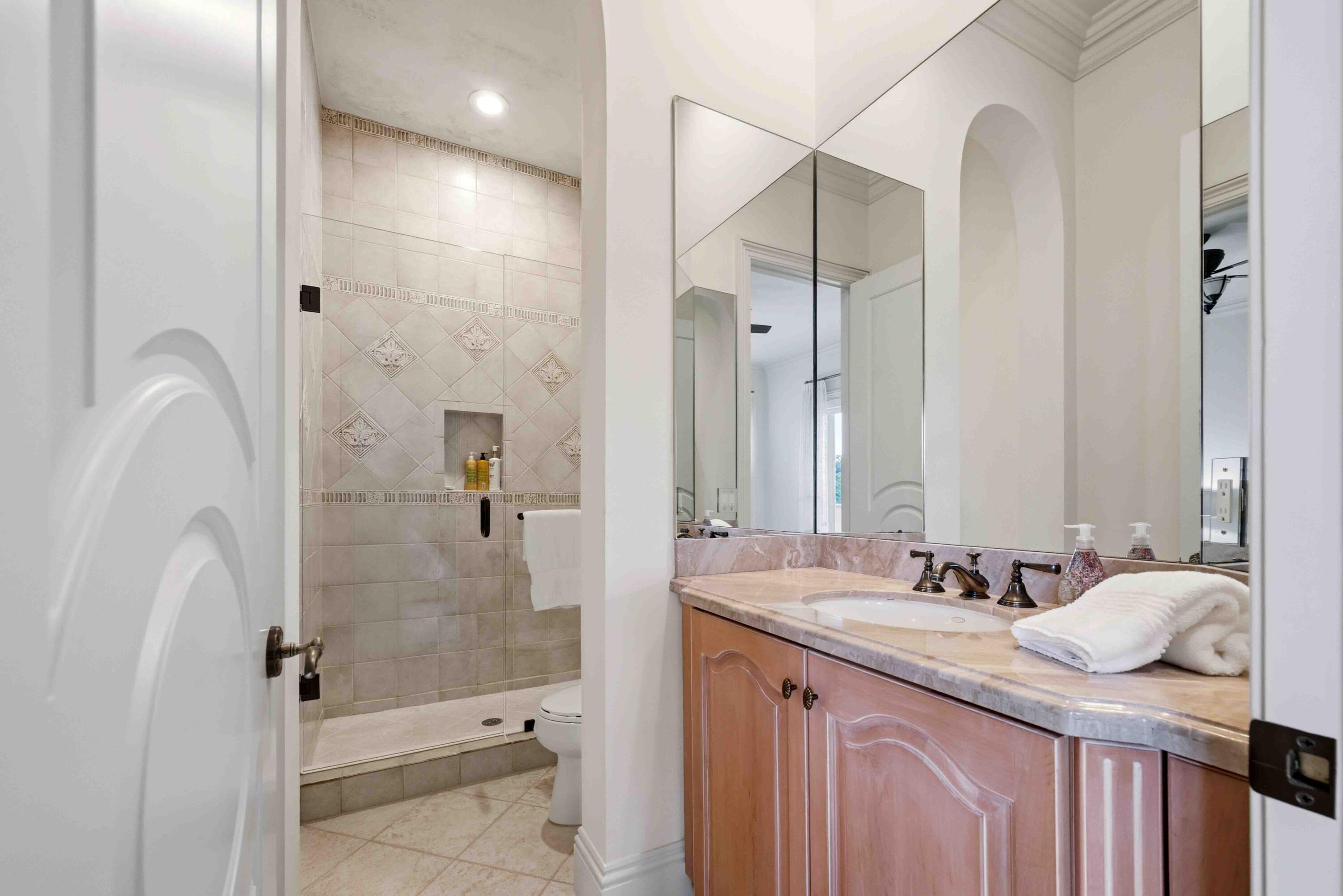 18118 Daybreak Drive Boca Raton, FL 33496 - Photo 53 of 84 a bathroom with a granite countertop sink a toilet and shower