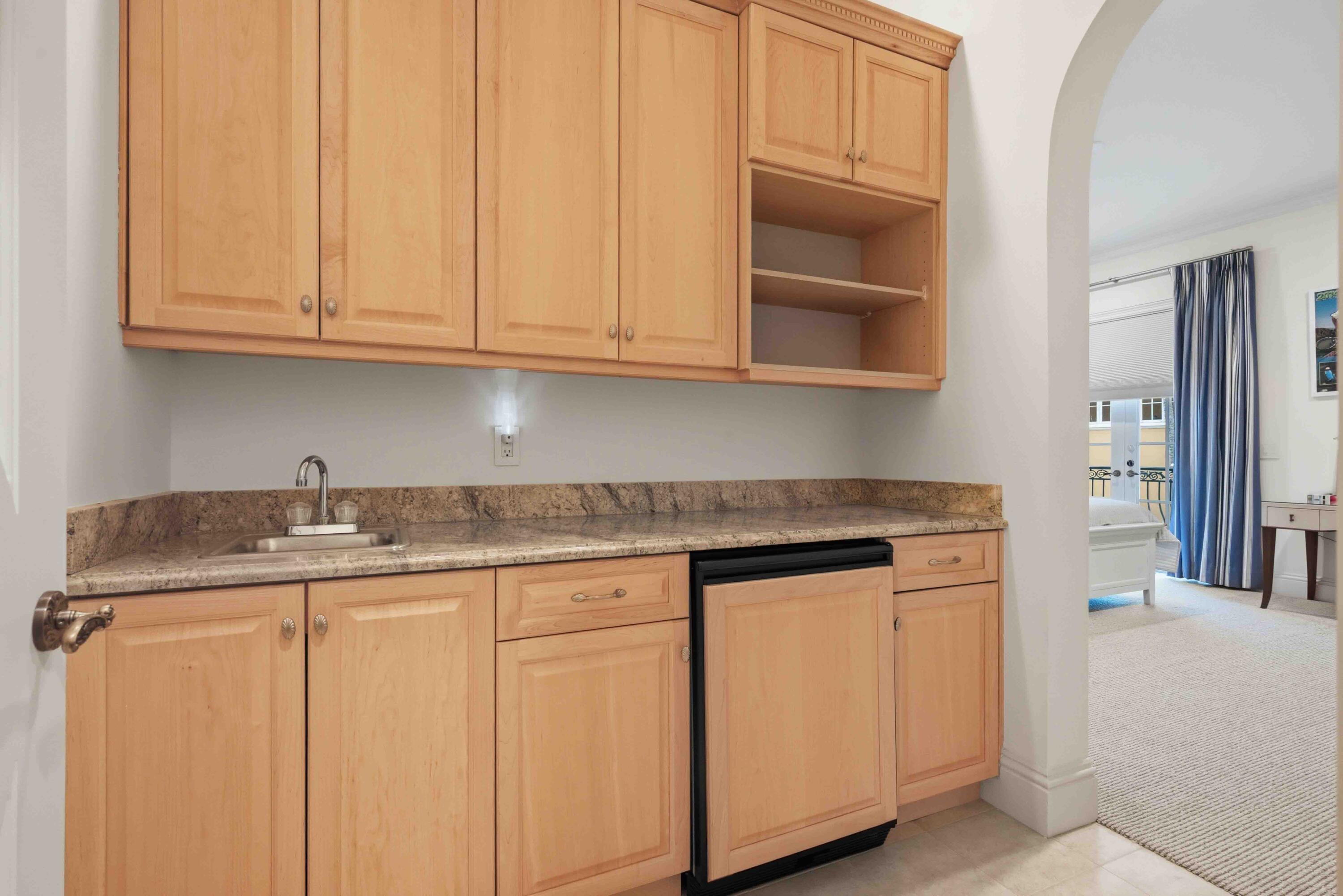 18118 Daybreak Drive Boca Raton, FL 33496 - Photo 59 of 84 a kitchen with granite countertop white cabinets and sink