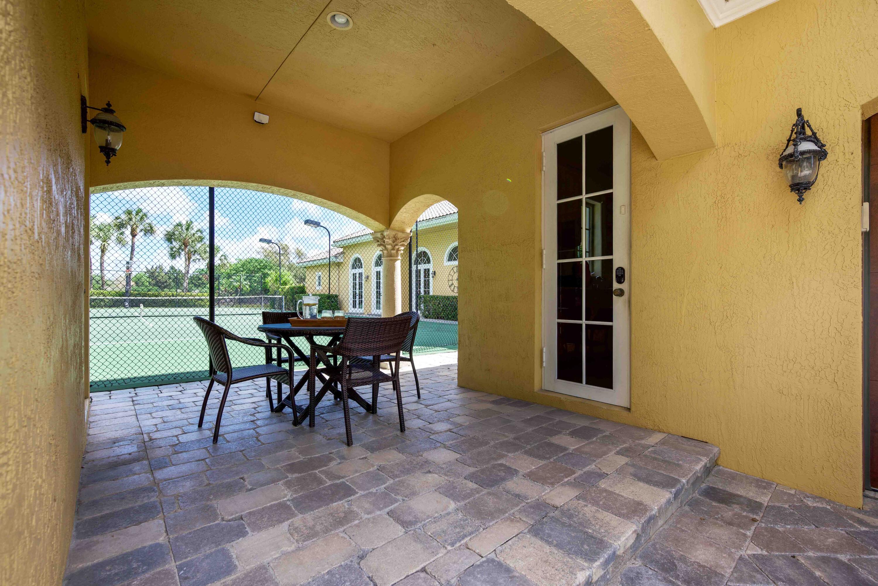 18118 Daybreak Drive Boca Raton, FL 33496 - Photo 61 of 84 a view of a dining room with furniture and a floor to ceiling window