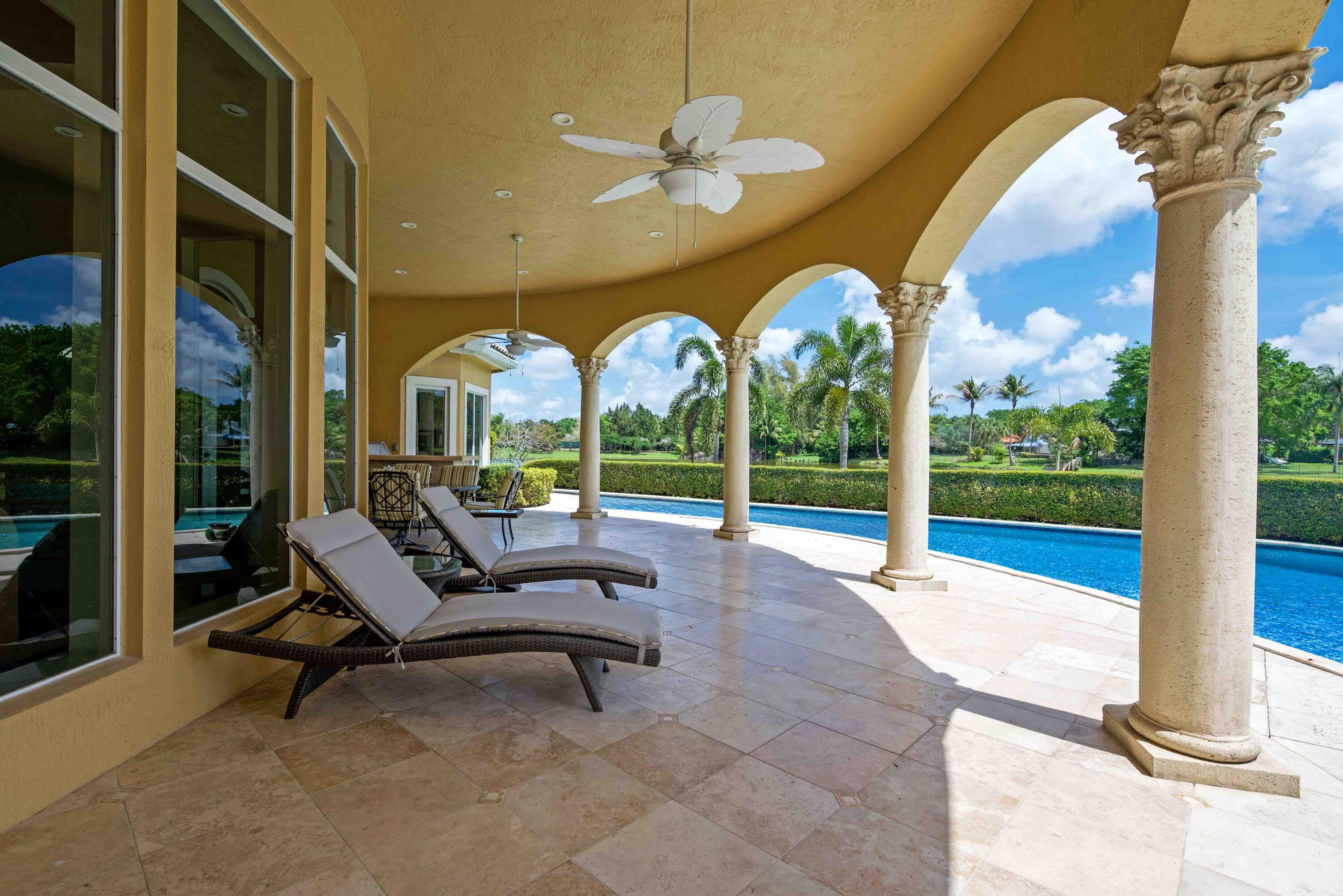 18118 Daybreak Drive Boca Raton, FL 33496 - Photo 69 of 84 a swimming pool with outdoor seating and yard