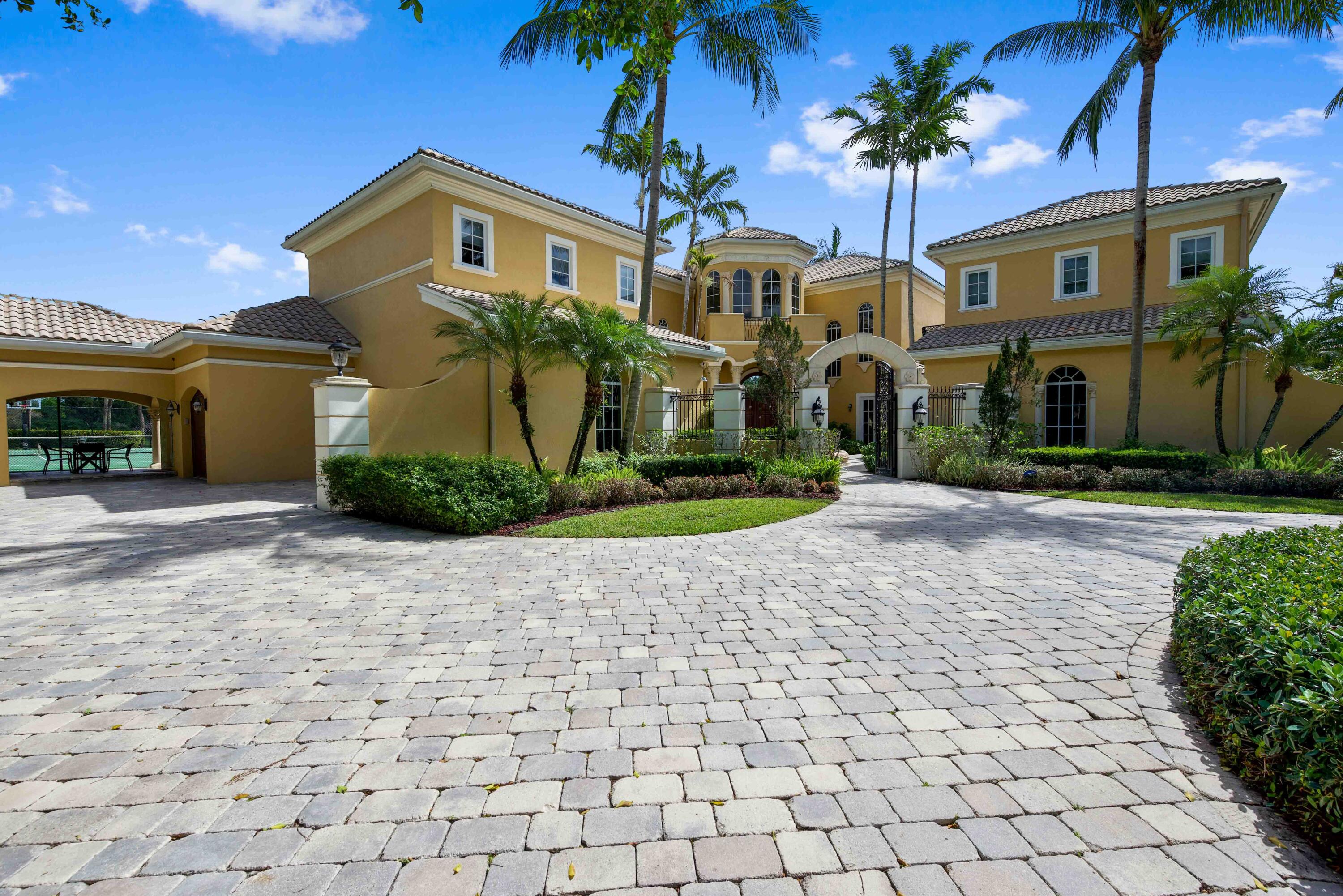18118 Daybreak Drive Boca Raton, FL 33496 - Photo 7 of 84 a front view of a house with a yard and potted plants