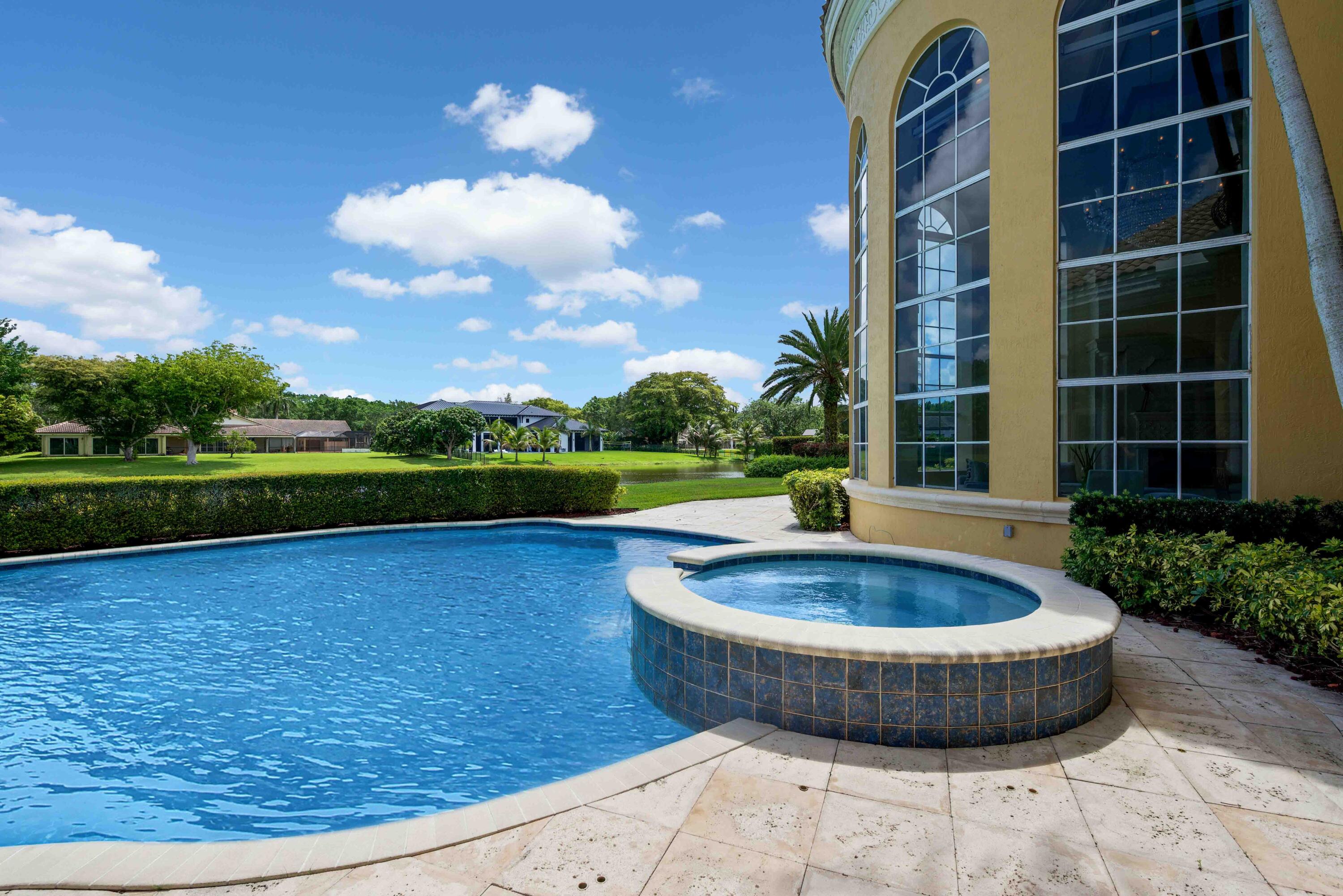 18118 Daybreak Drive Boca Raton, FL 33496 - Photo 71 of 84 a view of a swimming pool with a yard