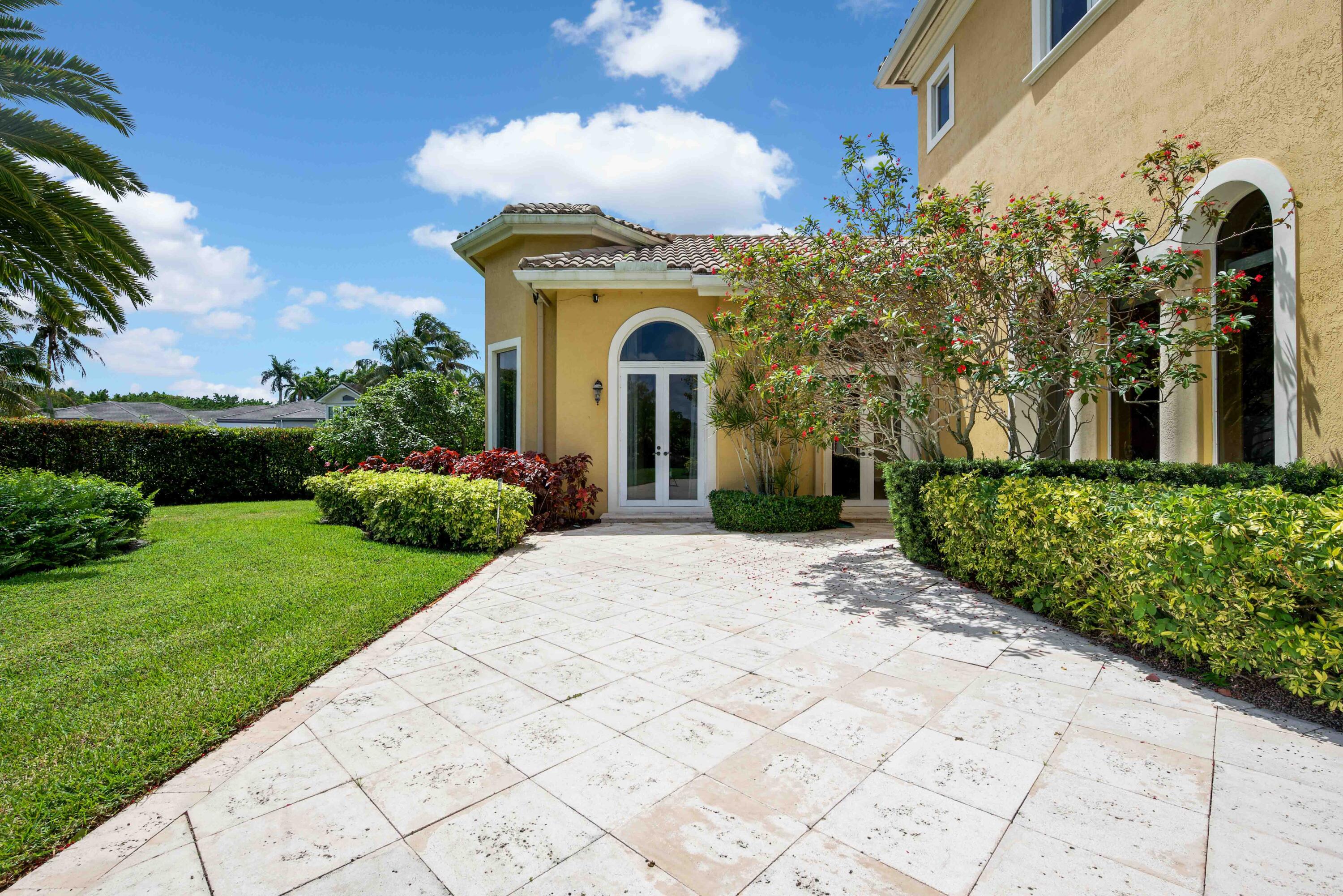 18118 Daybreak Drive Boca Raton, FL 33496 - Photo 74 of 84 a front view of a house with a garden