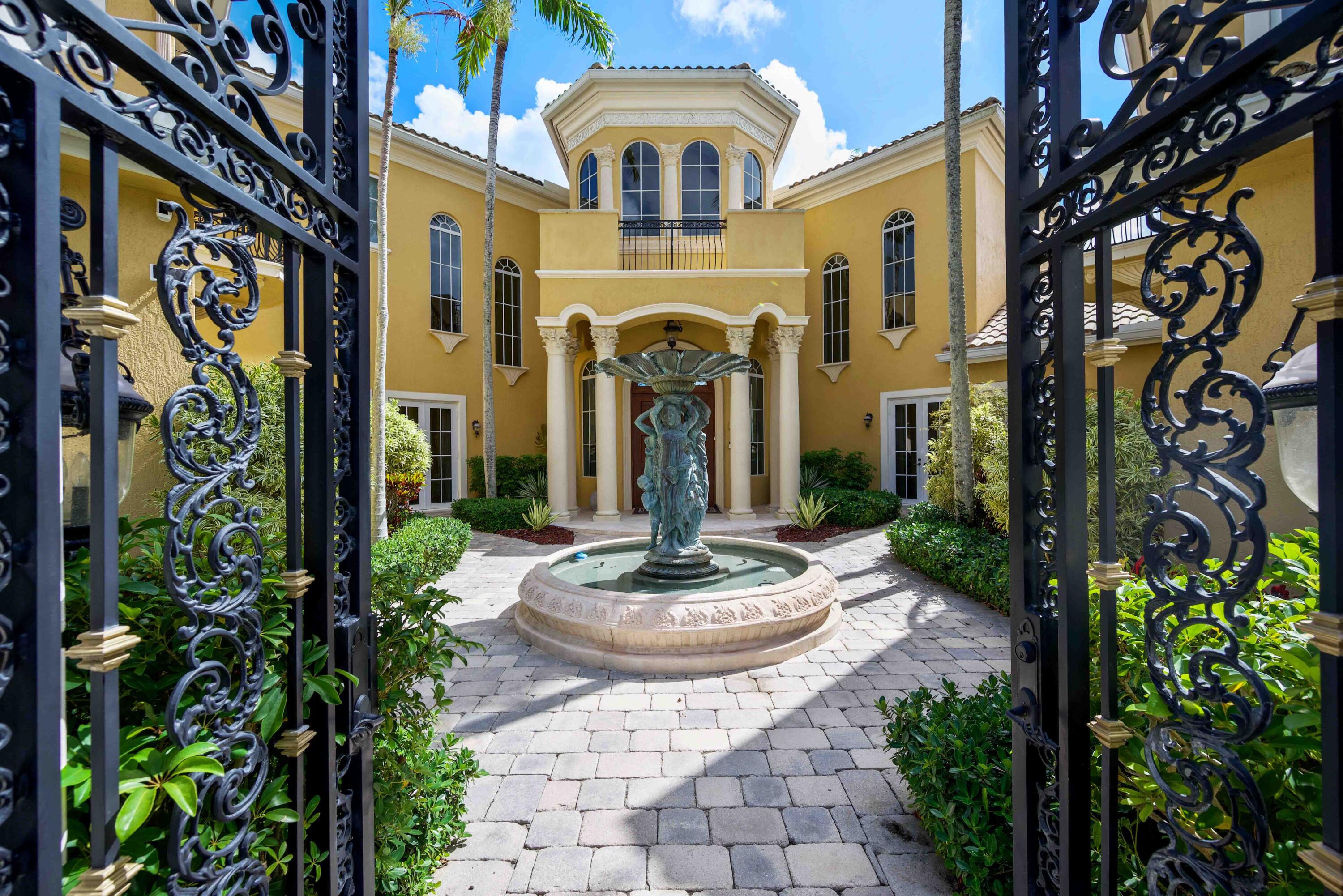18118 Daybreak Drive Boca Raton, FL 33496 - Photo 9 of 84 a front view of a house with garden view and a fountain