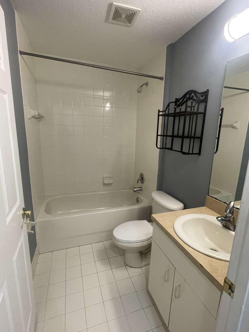 2944 Hidden Hills Road, Unit 1604 West Palm Beach, FL 33411 - Photo 5 of 11 a bathroom with a sink toilet and shower
