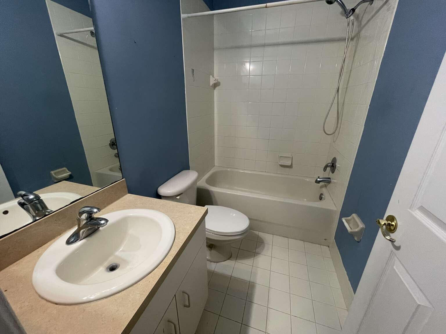 2944 Hidden Hills Road, Unit 1604 West Palm Beach, FL 33411 - Photo 6 of 11 a bathroom with a sink toilet and shower