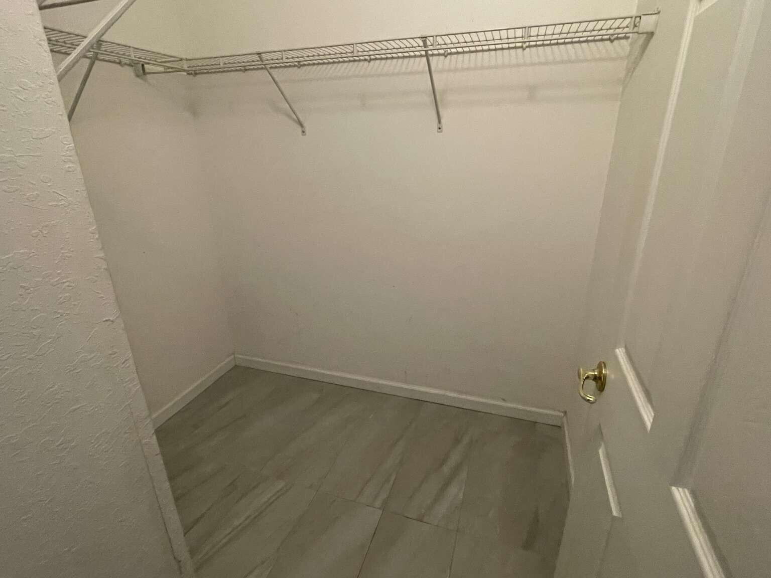 2944 Hidden Hills Road, Unit 1604 West Palm Beach, FL 33411 - Photo 8 of 11 a view of a room with racks on the wall