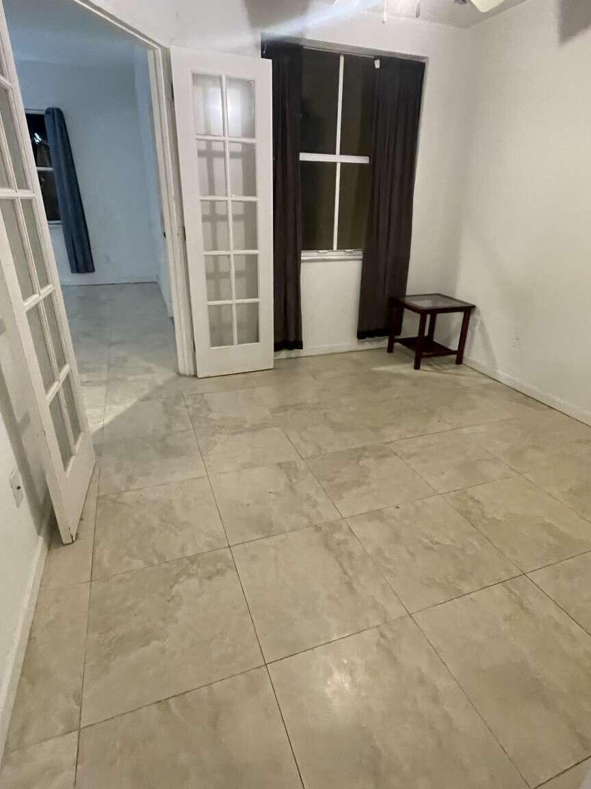 2944 Hidden Hills Road, Unit 1604 West Palm Beach, FL 33411 - Photo 10 of 11 a view of an empty room with a window