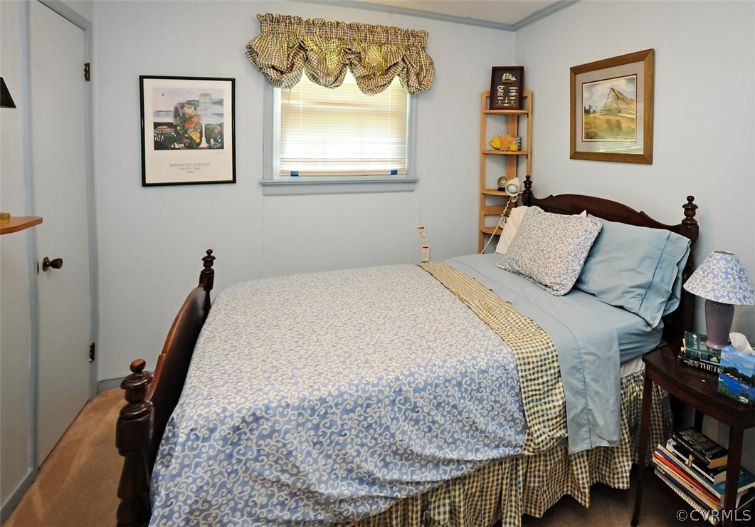 319 Beaumar Road Moon, VA 23119 - Photo 17 of 24 a bedroom with a bed and a painting on the wall