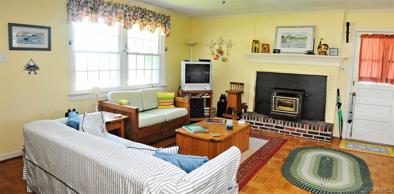 319 Beaumar Road Moon, VA 23119 - Photo 9 of 24 a living room with furniture a window and a fireplace