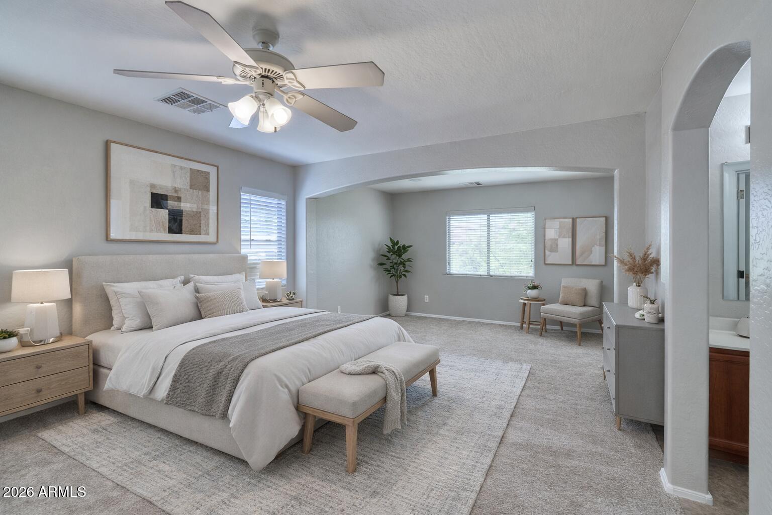 21619 West Durango Street Buckeye, AZ 85326 - Photo 16 of 30 a bedroom with a large bed couch and two windows