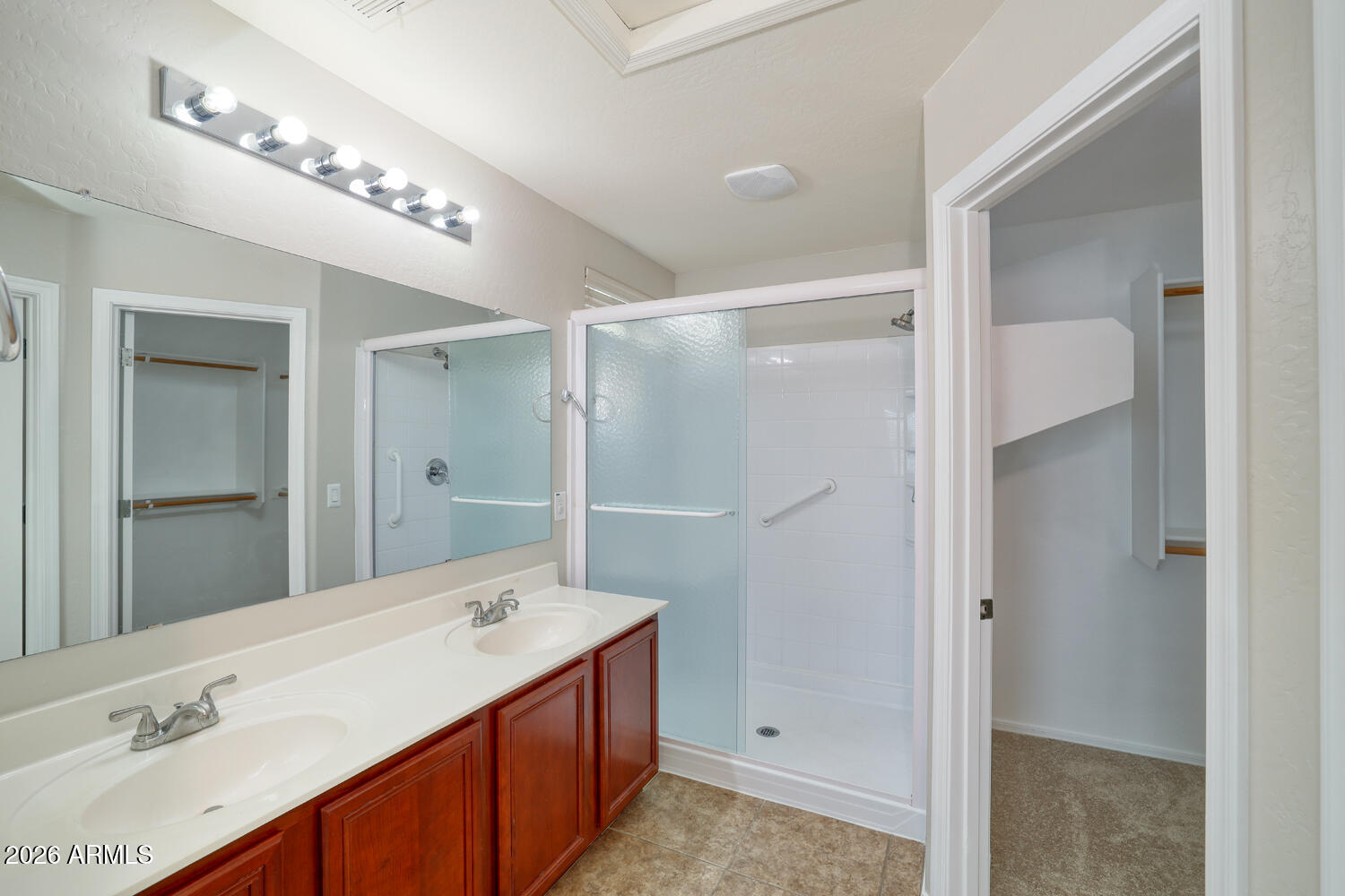 21619 West Durango Street Buckeye, AZ 85326 - Photo 18 of 30 a bathroom with a double vanity sink and a mirror