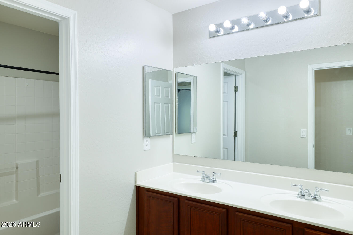 21619 West Durango Street Buckeye, AZ 85326 - Photo 23 of 30 a bathroom with a double vanity sink and a mirror