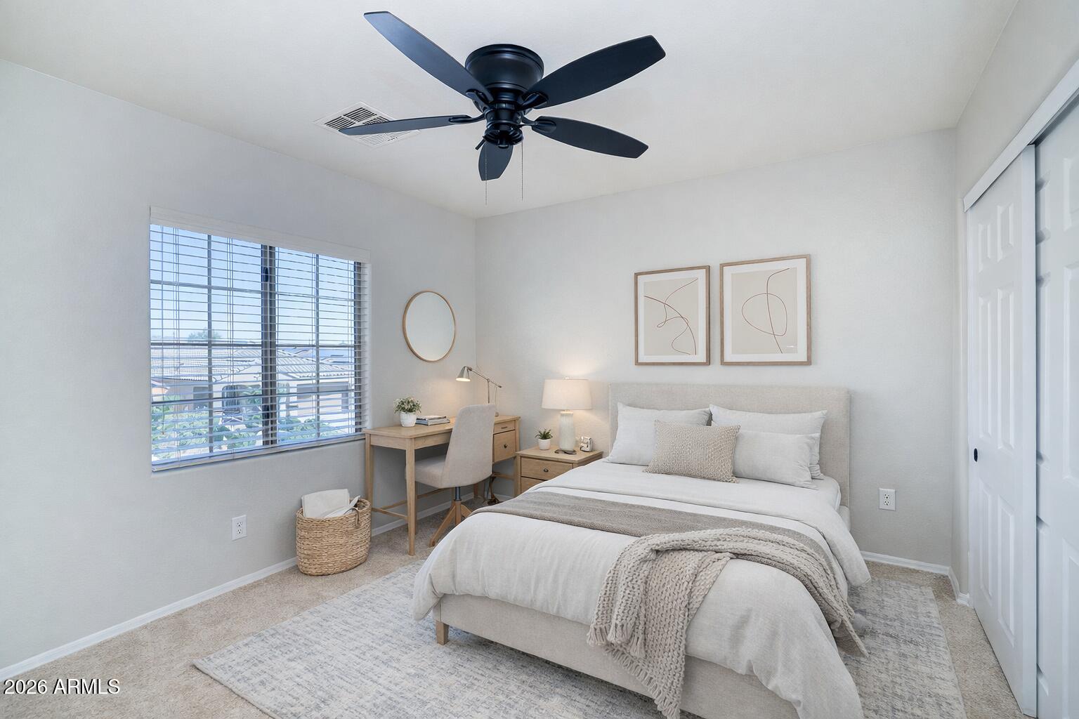 21619 West Durango Street Buckeye, AZ 85326 - Photo 25 of 30 a bedroom with a large bed and a chandelier