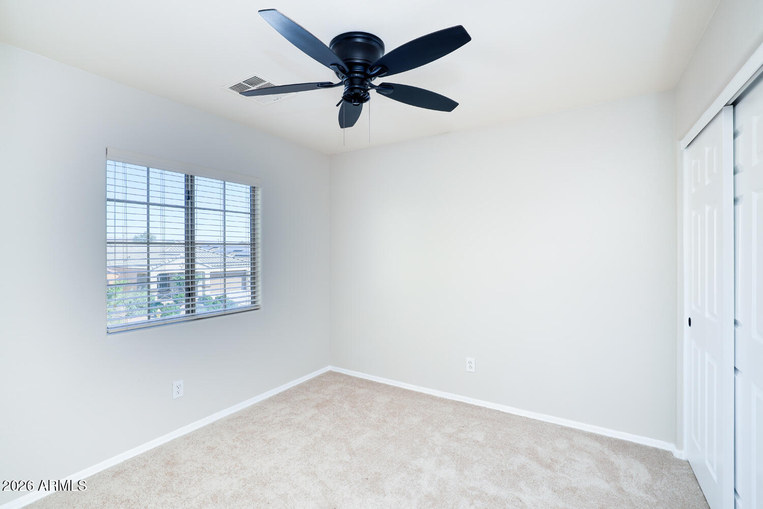 21619 West Durango Street Buckeye, AZ 85326 - Photo 26 of 30 an empty room with a window and a fan