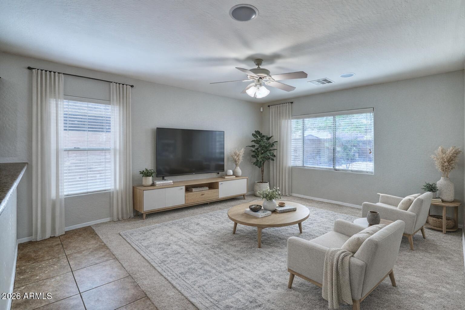 21619 West Durango Street Buckeye, AZ 85326 - Photo 8 of 30 a living room with furniture a flat screen tv and a window