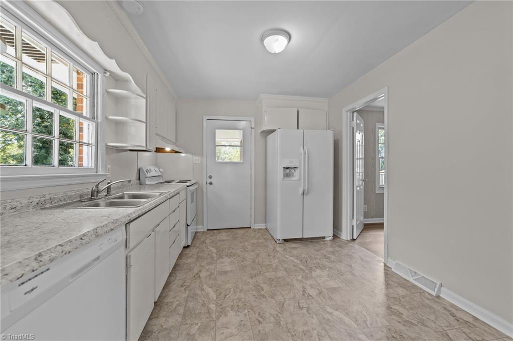 2507 Fontaine Road Greensboro, NC 27407 - Photo 6 of 34 Kitchen with double bowl sink and windows overlooking the backyard.