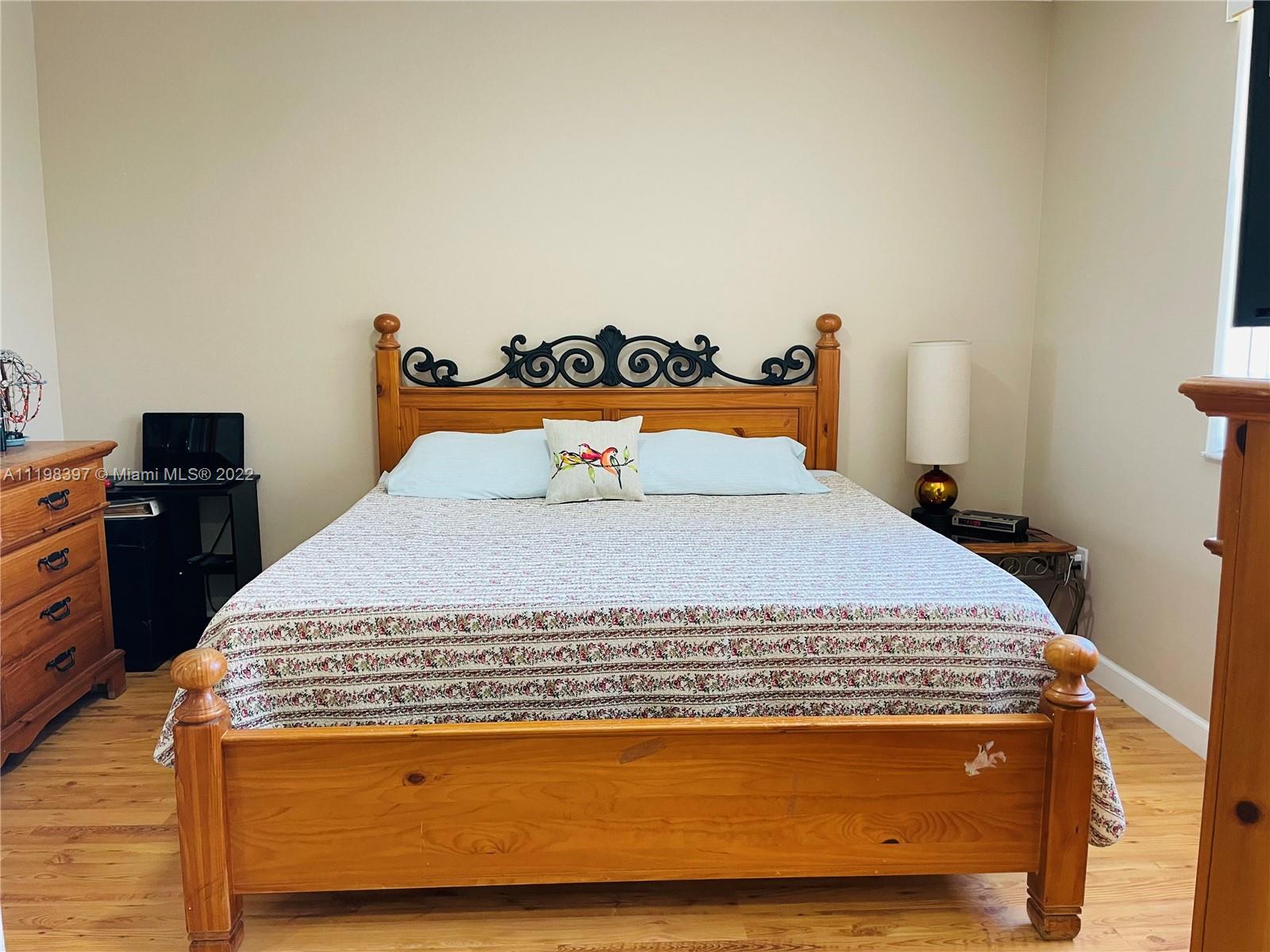 10975 Southwest 246th Street Homestead, FL 33032 - Photo 11 of 20 a bed sitting in a bedroom next to a window
