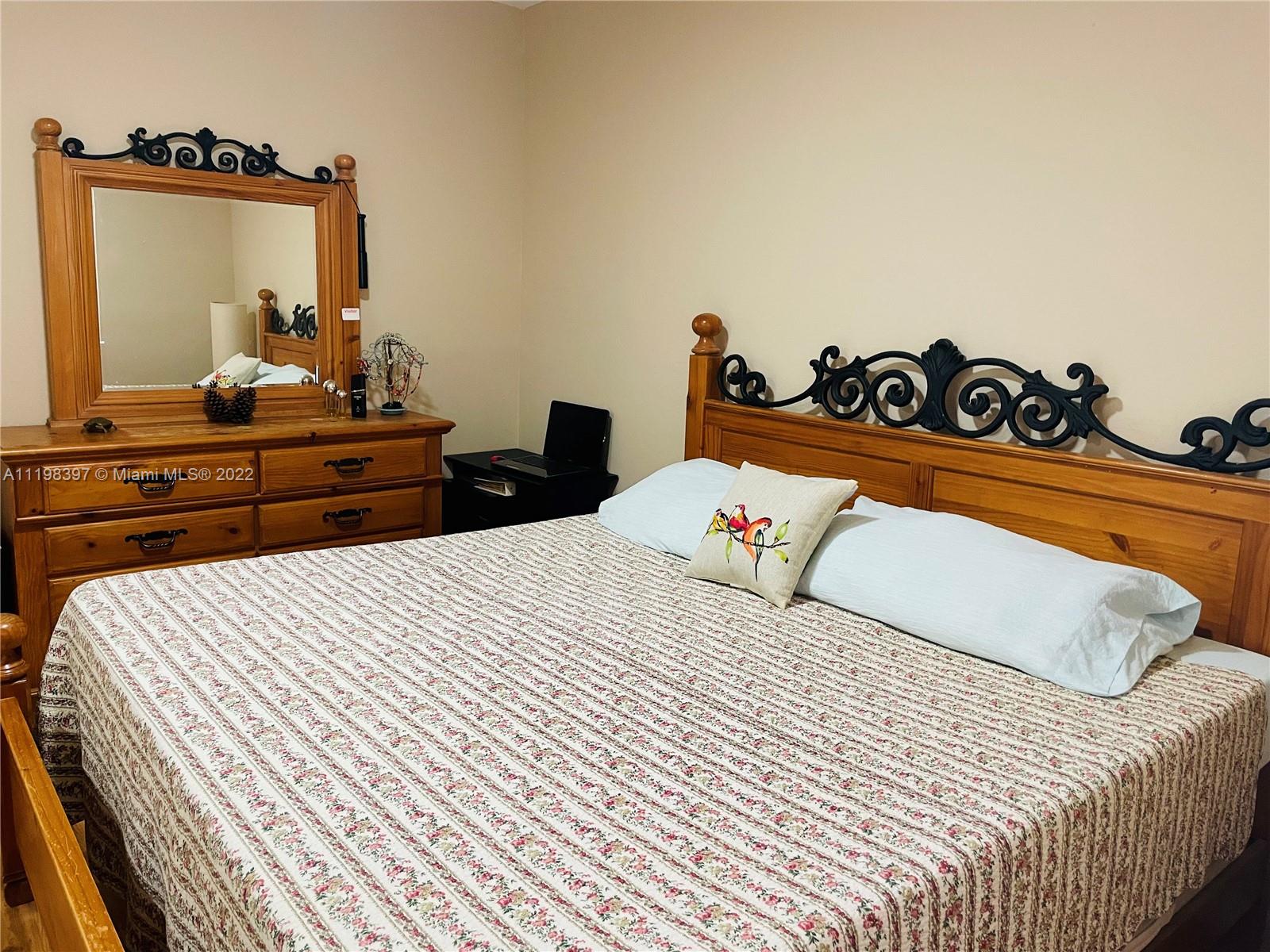 10975 Southwest 246th Street Homestead, FL 33032 - Photo 12 of 20 a bedroom with a bed and a dresser