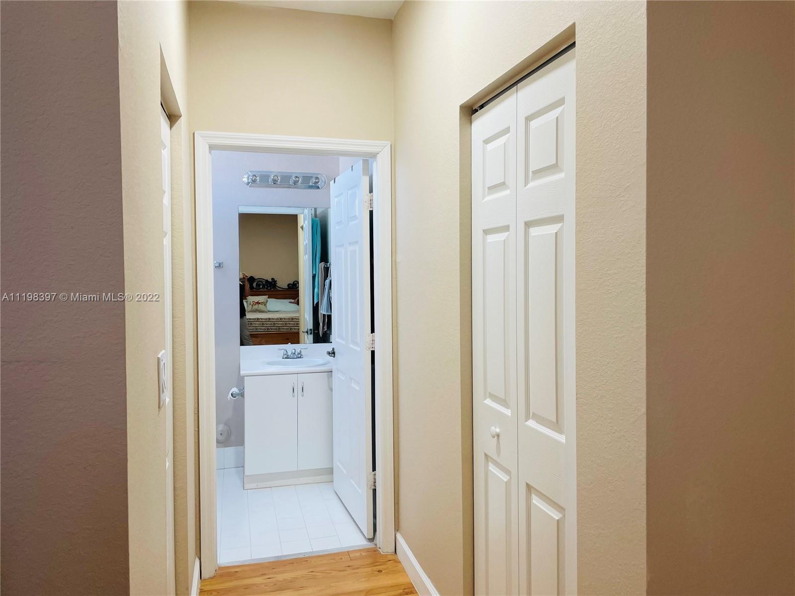 10975 Southwest 246th Street Homestead, FL 33032 - Photo 13 of 20 a view of a bathroom from a hallway