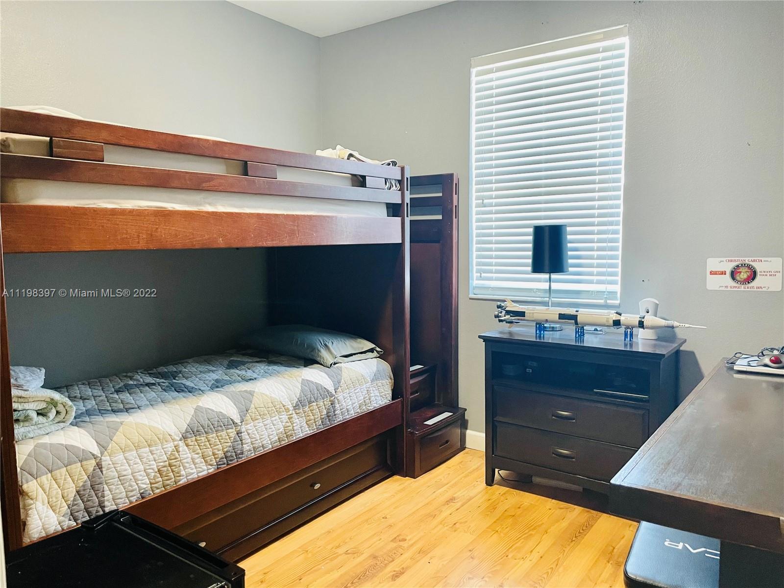 10975 Southwest 246th Street Homestead, FL 33032 - Photo 16 of 20 a bedroom with a bed and a window