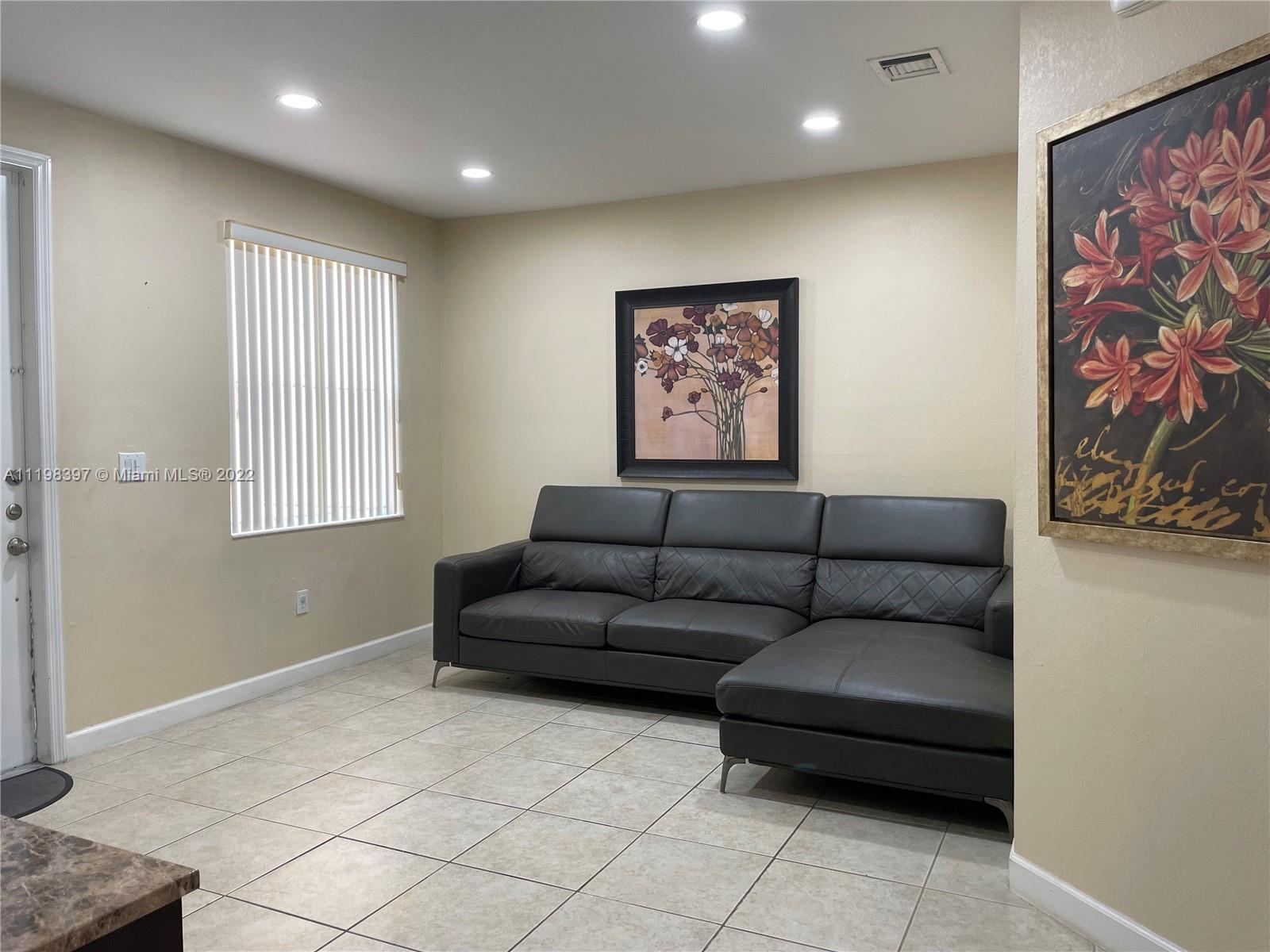 10975 Southwest 246th Street Homestead, FL 33032 - Photo 2 of 20 a living room with furniture and a window