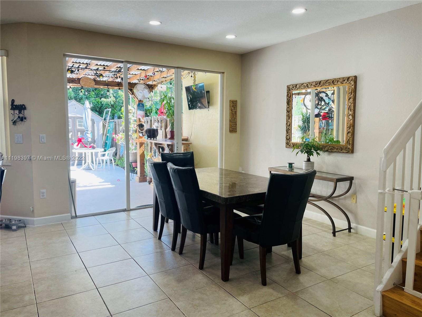 10975 Southwest 246th Street Homestead, FL 33032 - Photo 3 of 20 a view of a dining room with furniture window and outside view