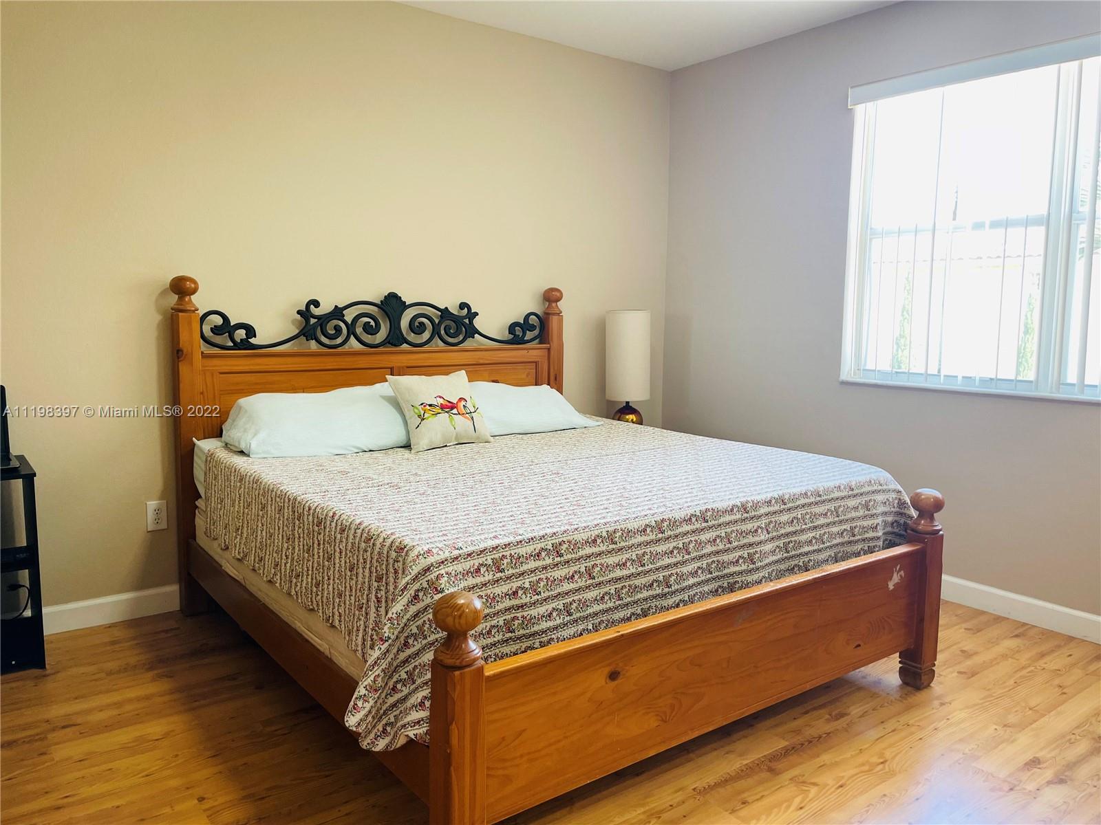 10975 Southwest 246th Street Homestead, FL 33032 - Photo 10 of 20 a bed sitting in a bedroom next to a window