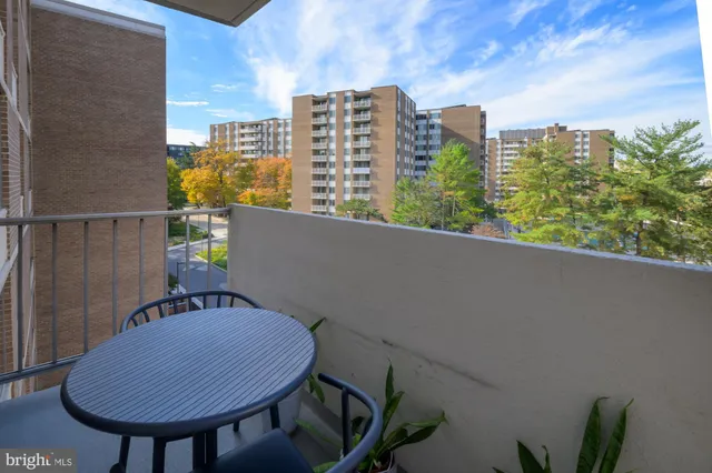 a view of balcony with table and chairs