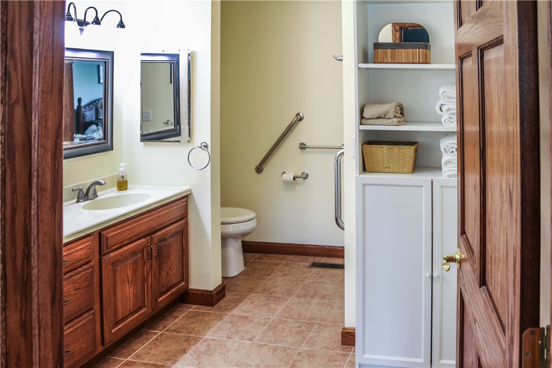 9 South Country Club Road Mattoon, IL 61938 - Photo 14 of 20 a bathroom with a sink a toilet and a mirror
