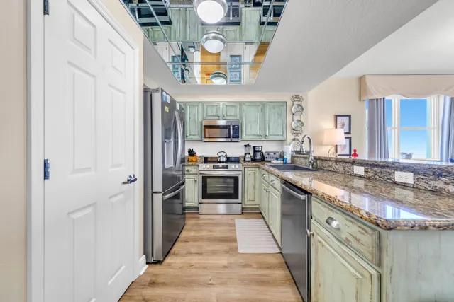 a kitchen with stainless steel appliances granite countertop a stove and a sink