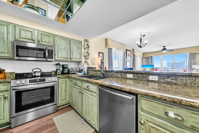 a kitchen with stainless steel appliances granite countertop a stove and a sink