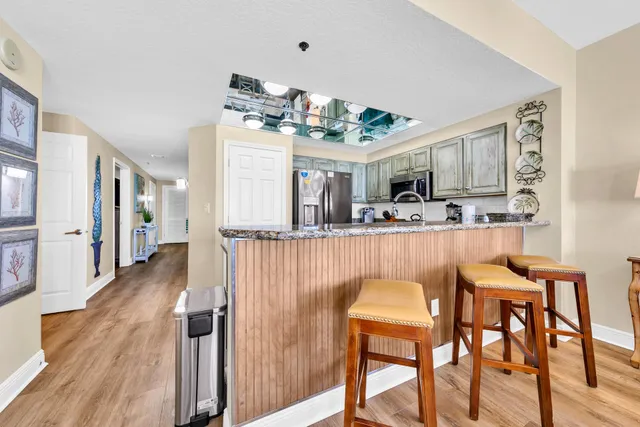 a dining room filled chandelier and wooden floor