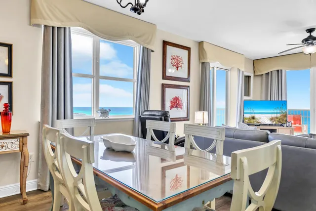a view of a dining room with furniture a chandelier and wooden floor
