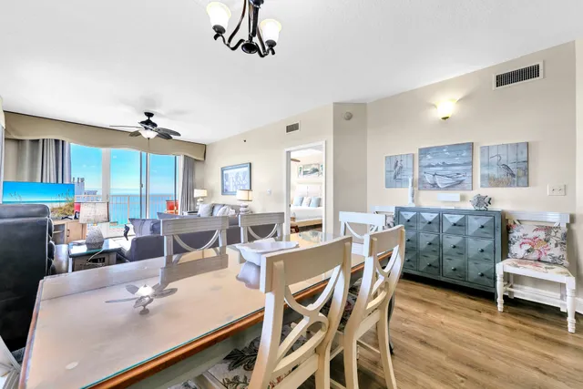 a dining room with furniture a rug and a chandelier