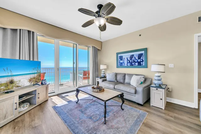 a living room with furniture and a ceiling fan
