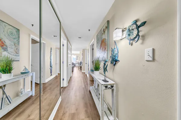 a view of a hallway with wooden floor
