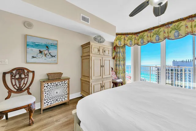 a bedroom with a bed a dresser and chair