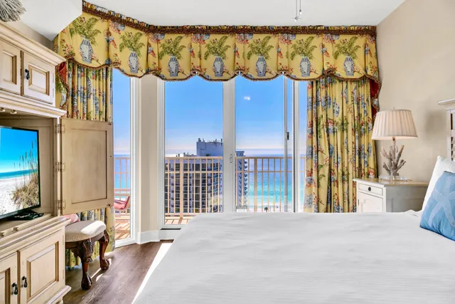 a bedroom with a bed and a mirror on the dresser