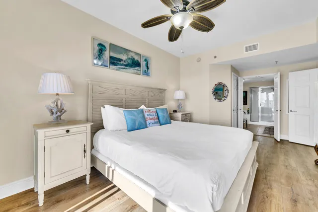 a spacious bedroom with a bed and a chandelier