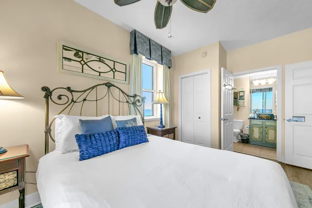 a bedroom with a bed mirror and window