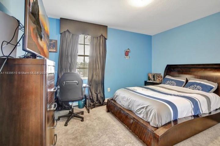 5078 Southwest 183rd Avenue Miramar, FL 33029 - Photo 11 of 15 a bedroom with a bed chair and a window
