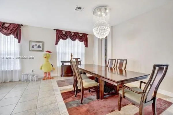 a view of a dining room with furniture wooden floor and a chandelier