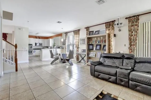 a living room with furniture and a book shelf