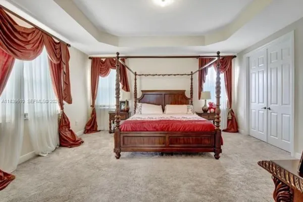 a bed sitting in a room next to a window