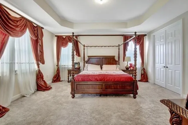 a bed sitting in a room next to a window