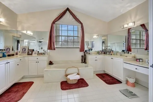 a large white kitchen with cabinets