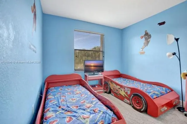 a bedroom with bed and a window