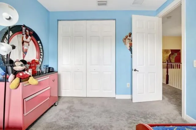 a bedroom with bed and a window