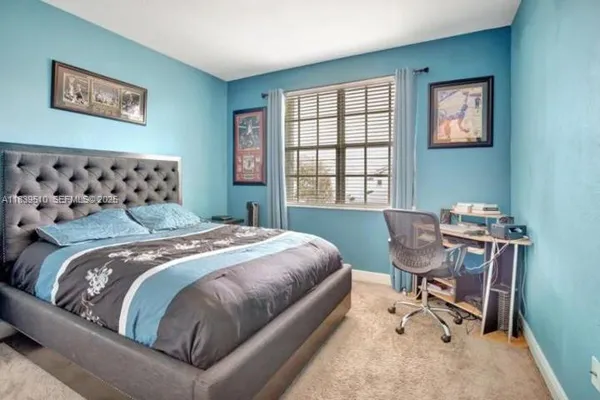 a bedroom with a bed chair and a window